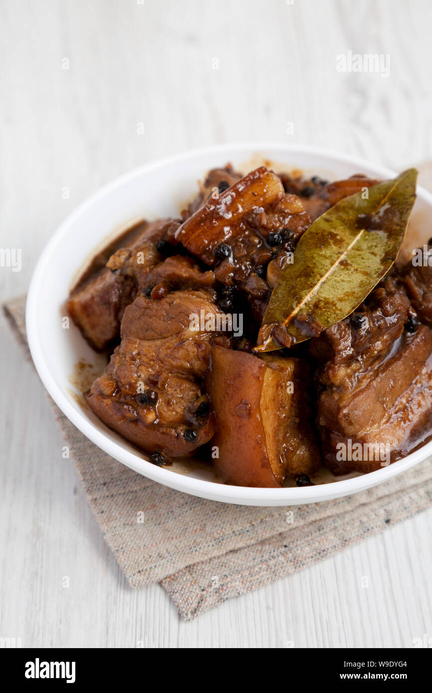 Homemade Filipino Adobo Pork with rice on a white wooden background ...