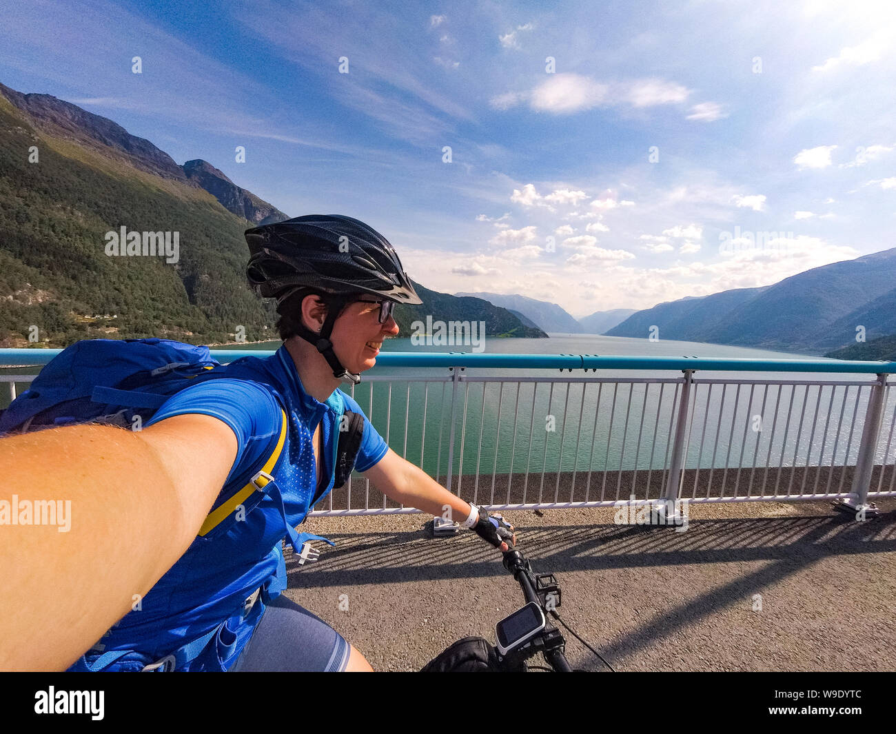 Theme of mountain biking in Scandinavia. human tourist in helmet and  sportswear on bicycle in Norway on Hardanger Bridge suspension bridge  thrown Stock Photo - Alamy