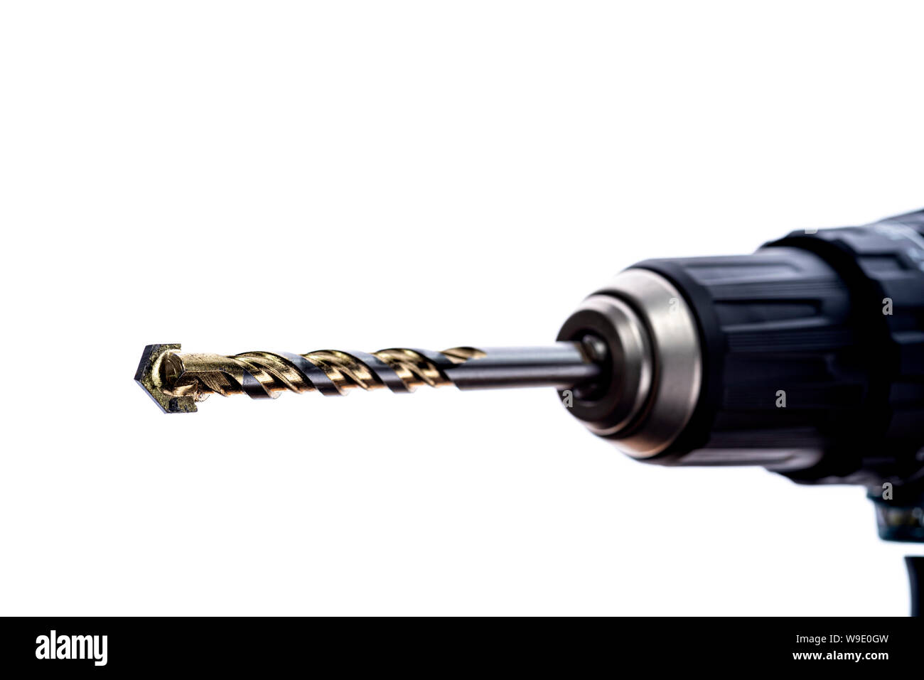 Close up of tungsten carbide tipped drill bit, in the chuck of an electric drill. Stock Photo