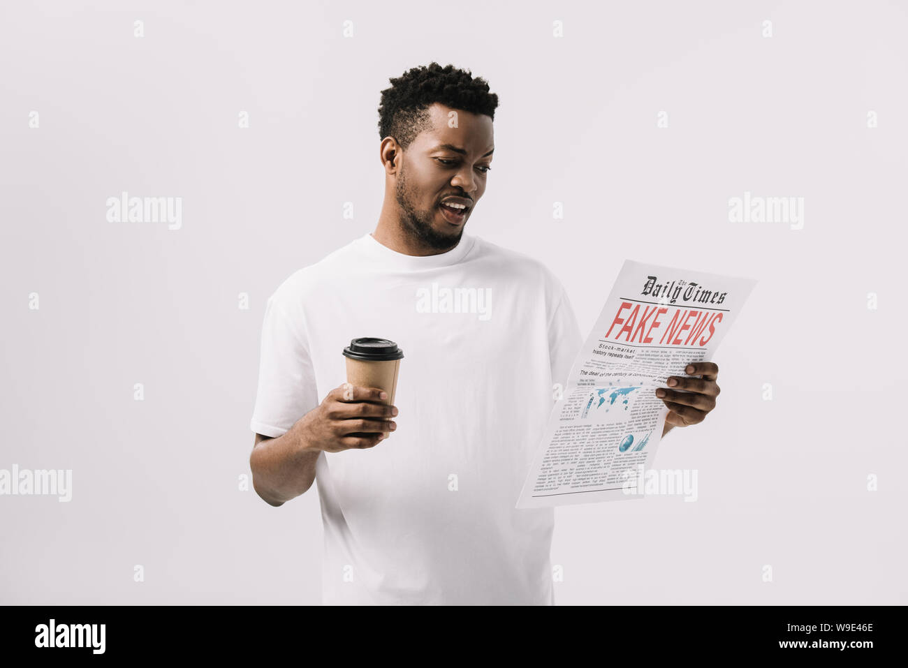handsome african american man holding paper cup and reading newspaper ...