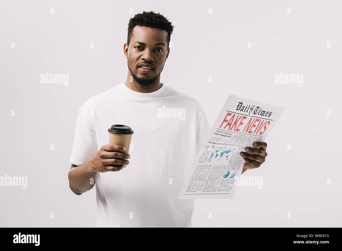 handsome african american man holding paper cup and newspaper with fake ...