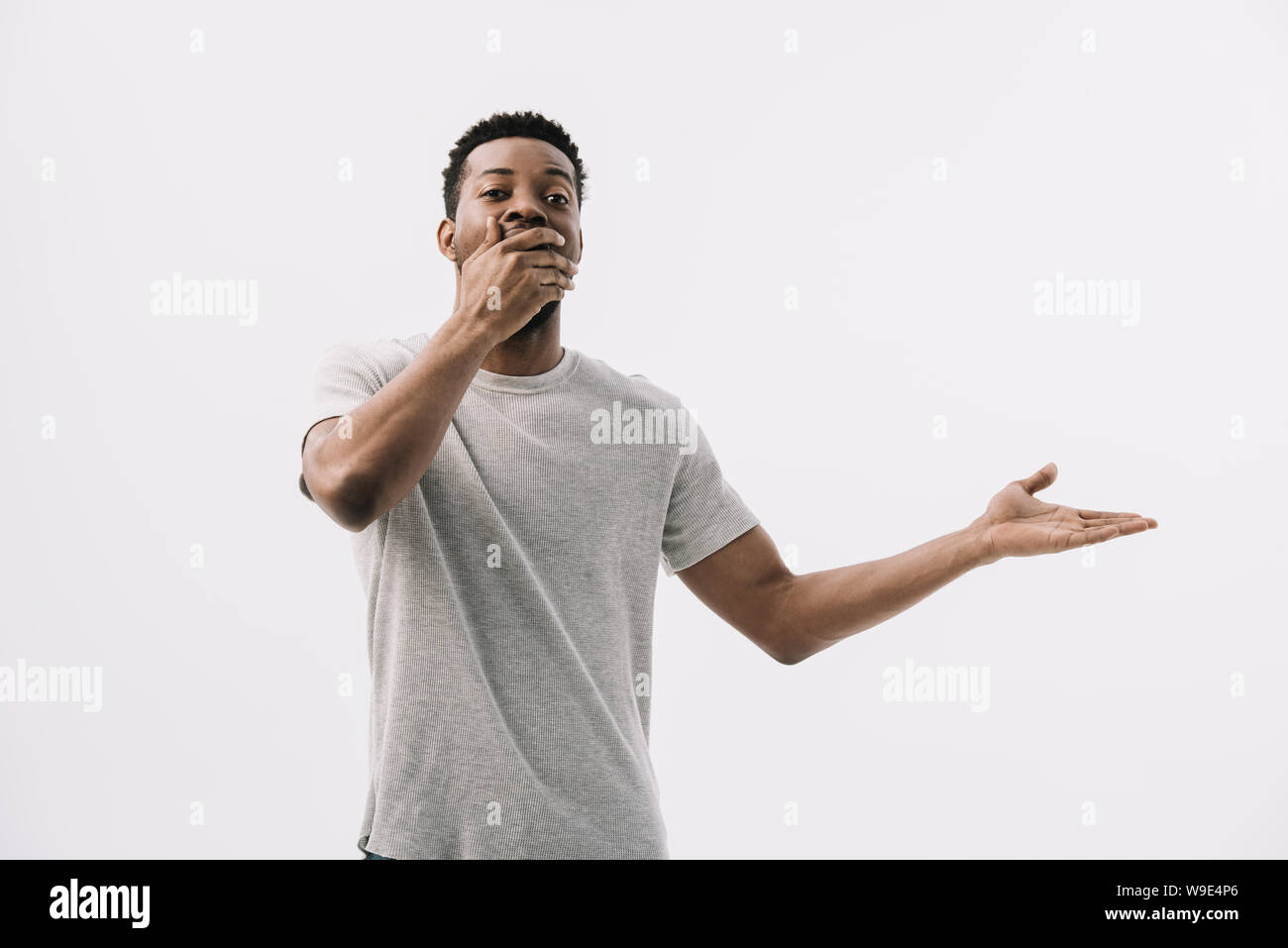 curly african american man covering face and gesturing isolated on ...