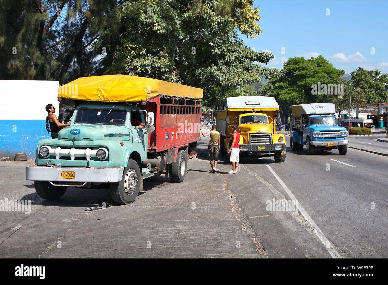 SANTIAGO, CUBA - FEBRUARY 9, 2011: People ride truck buses (camion) in Santiago de Cuba. Due to embargo Cuba had problems acquiring normal buses. Stock Photo