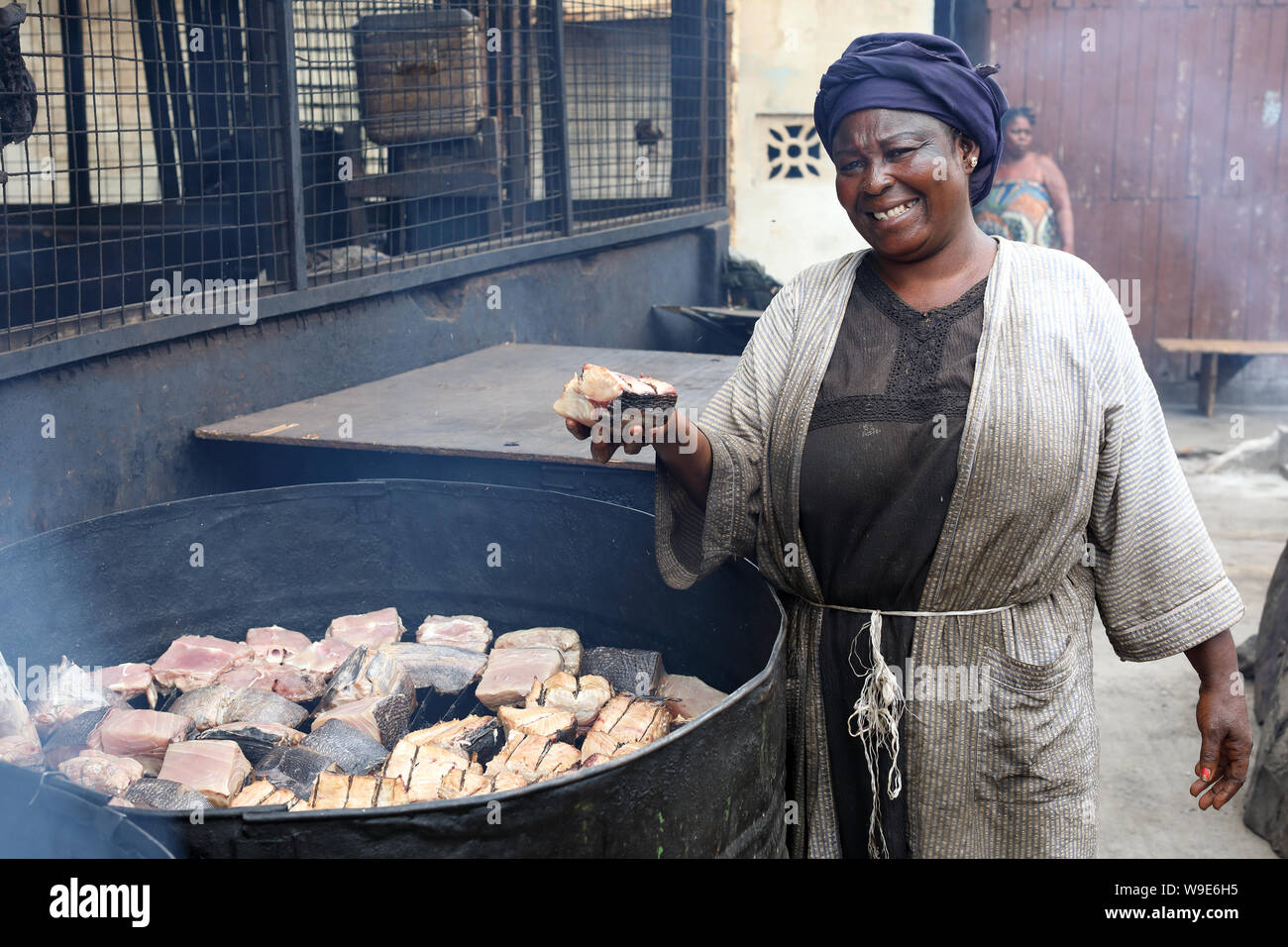 Market woman sells smoked fish in the fishing village Jamestown in