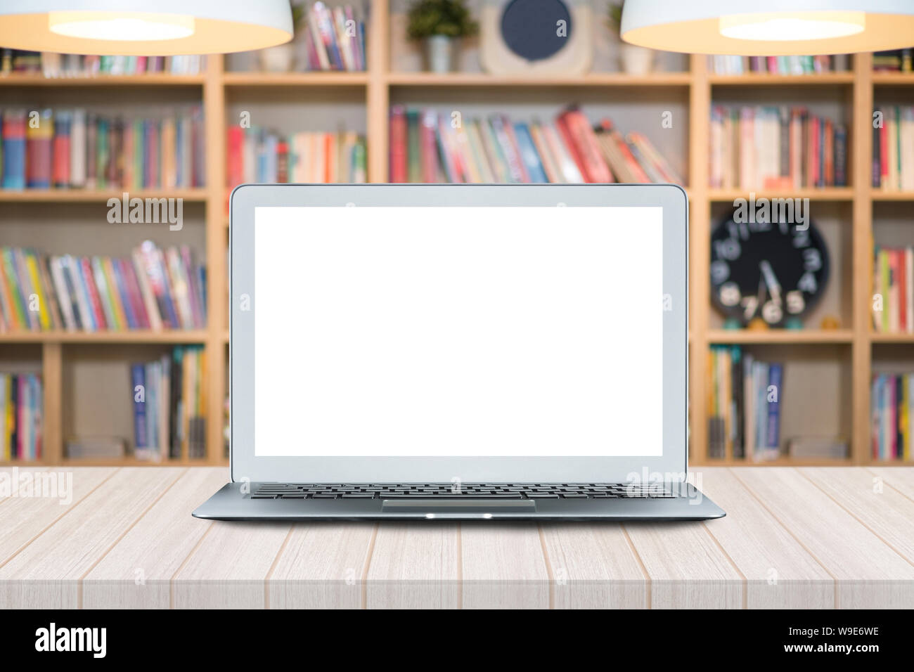 Smart modern laptop with white blank screen on wooden table in Co ...