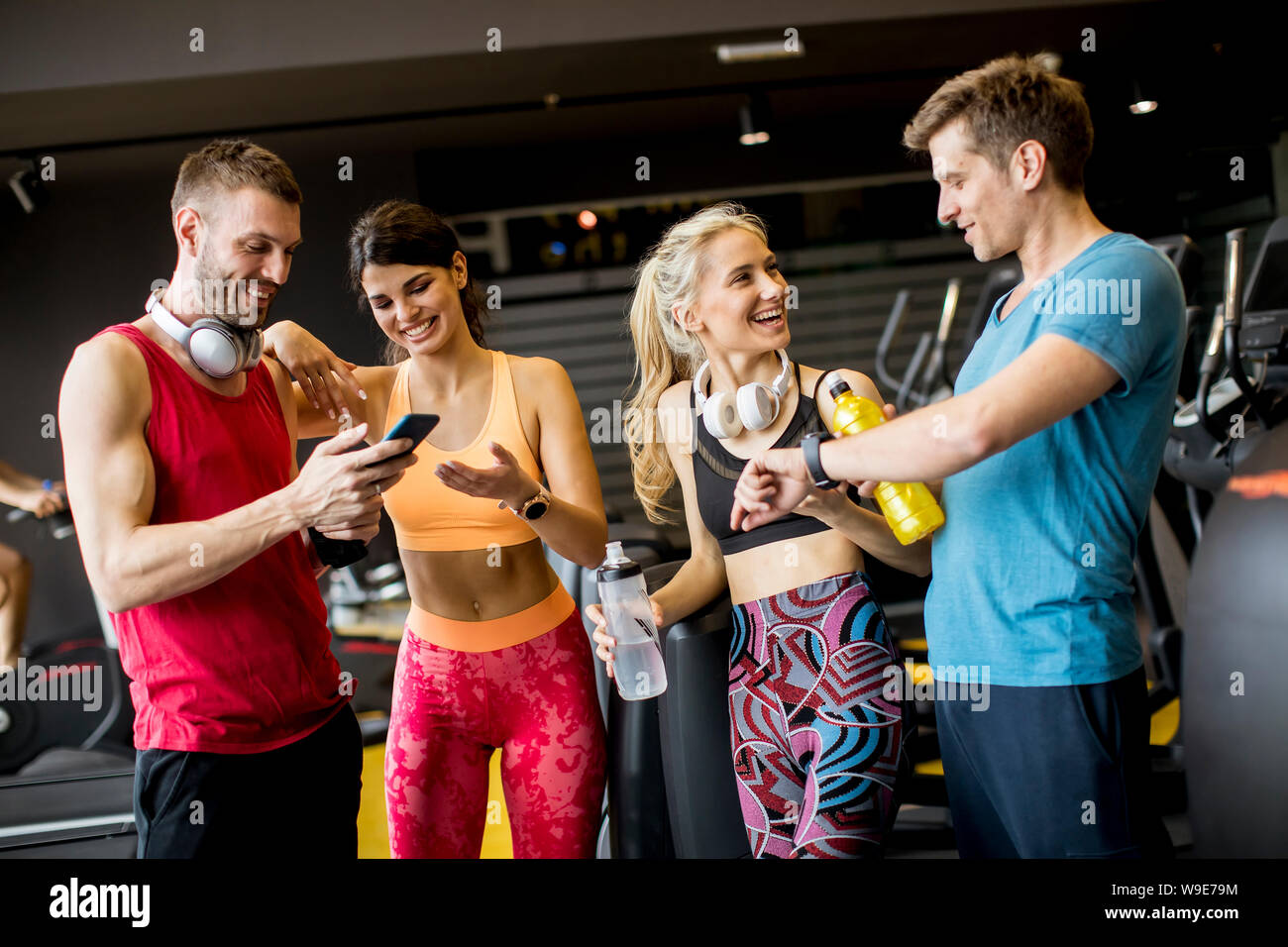 Group of sporty young people standing at the gym Stock Photo - Alamy