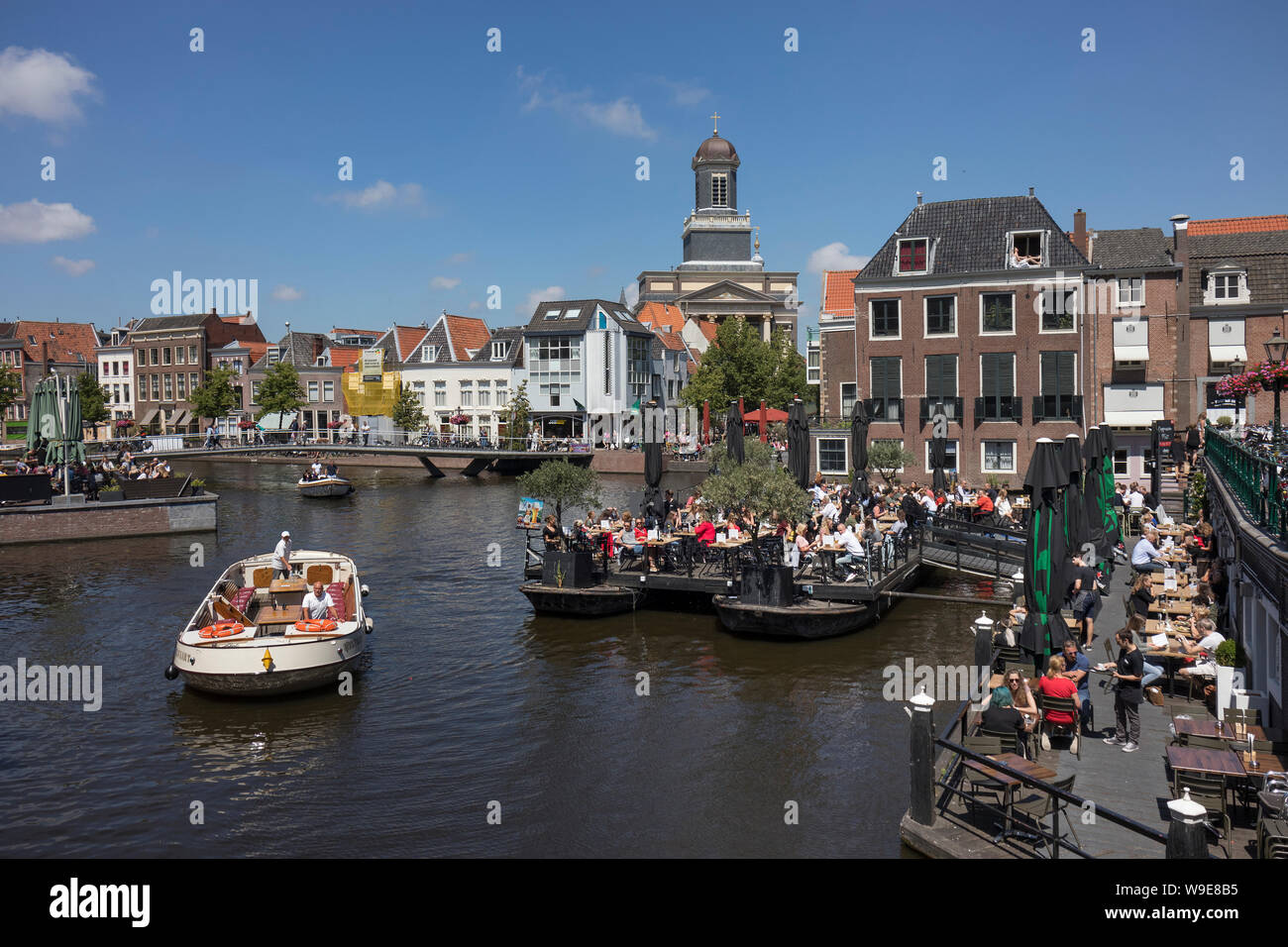 Leiden, Holland - July 05, 2019: Restaurant terrace on boats at the crossing of the Oude and Nieuwe Rijn Stock Photo