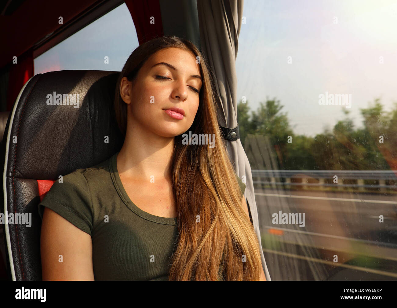 Young beautiful woman sleeping sitting in the bus. Bus passenger