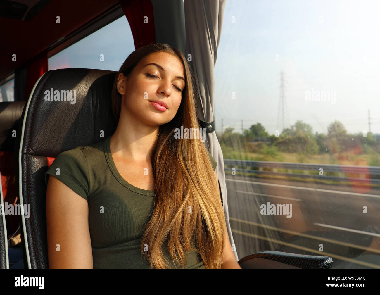 Young beautiful woman sleeping sitting in the bus. Bus passenger