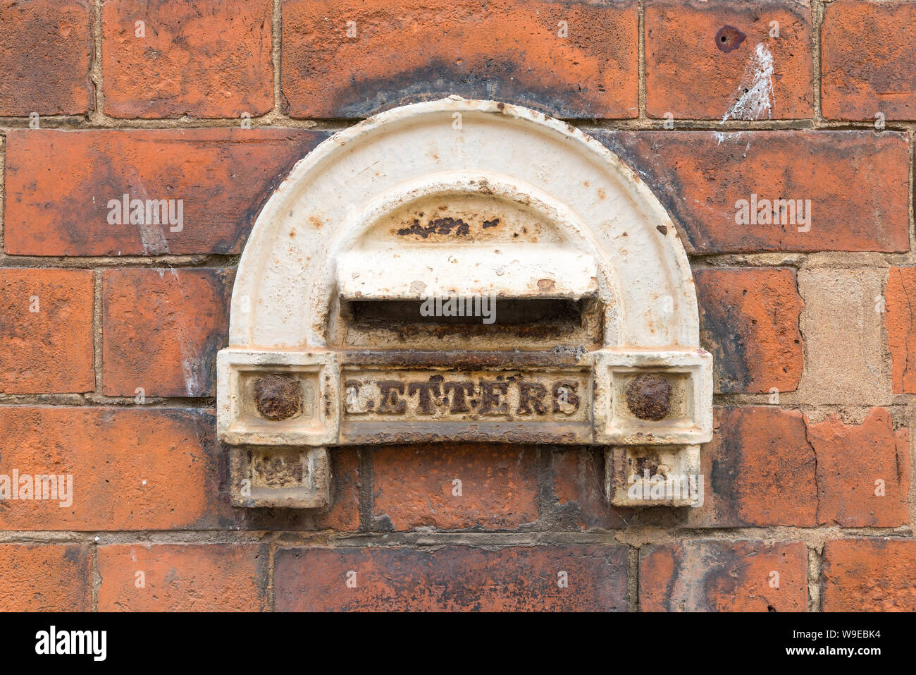 Traditional small letter box in the historic Gun Quarter in Aston, Birmingham which allowed small valuable items to be posted but not removed Stock Photo