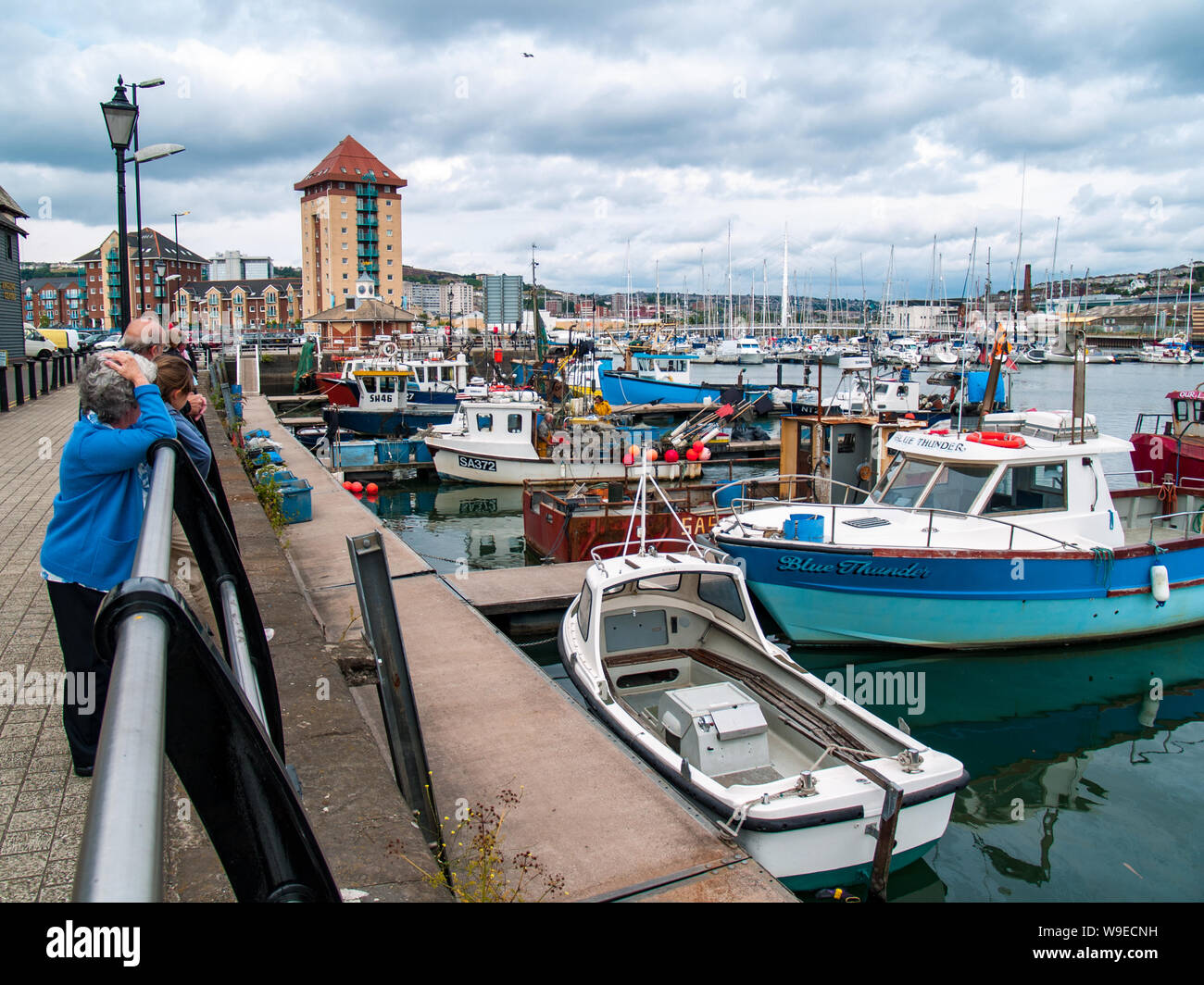 Swansea marina looking towards the Sail Bridge. Fishing boats can be seen in the foreground and private boats and yachts towards the bridge. Wales, UK Stock Photo