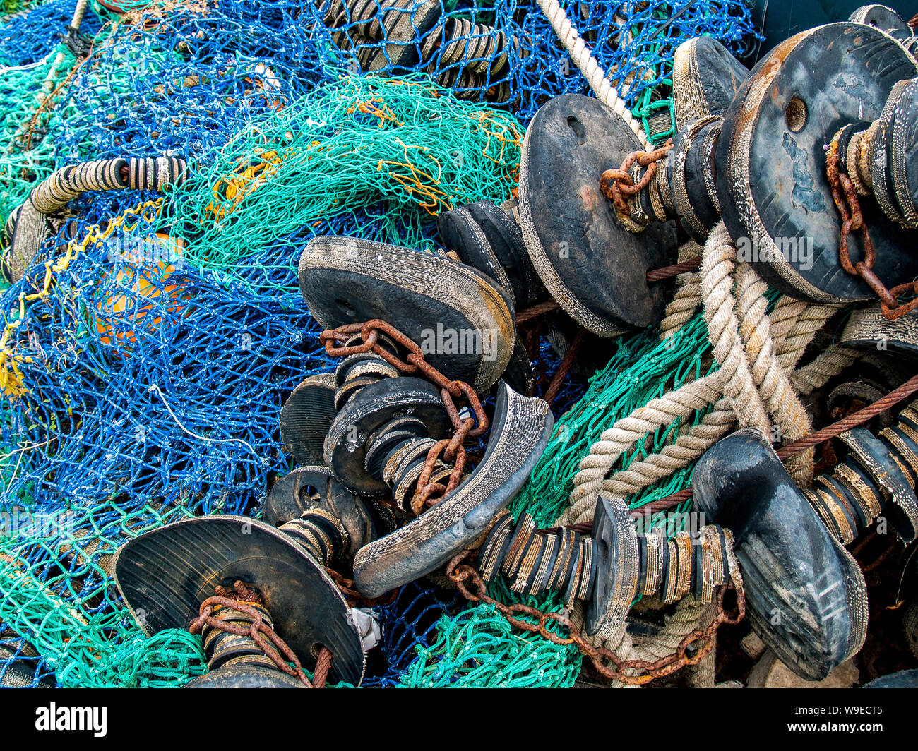 Swansea marina. Fishing nets, trawls, ropes and metal chains. Fishing equipment piled up. Wales, UK. Stock Photo