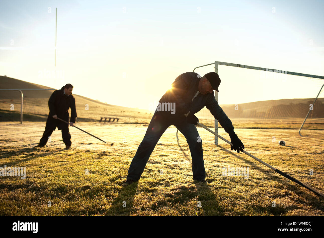 Groundskeepers raking a soccer field Stock Photo Alamy