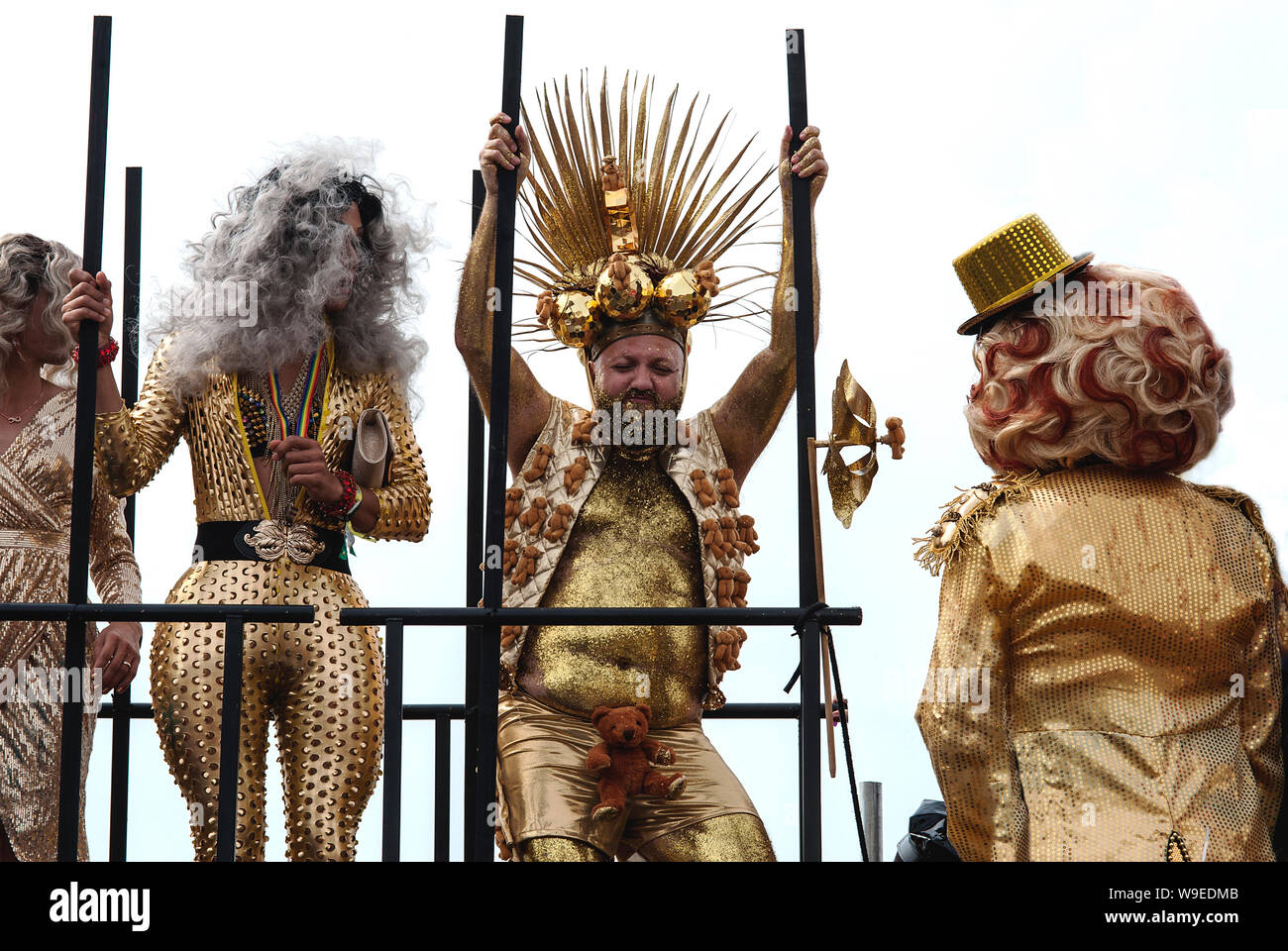 Pride, Brighton and Hove, 2019. Transvestites and gay men in glamorous golden costumes on a float at Brighton Pride parade. Stock Photo