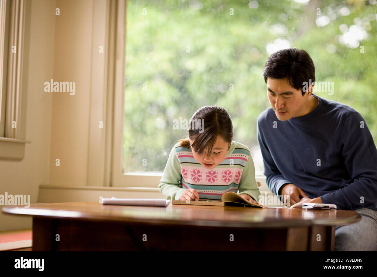 Father helping his daughter with her homework Stock Photo - Alamy