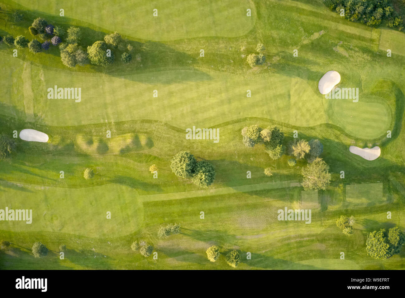 Aerial view of links golf course during summer showing green and bunkers at driving range Stock Photo