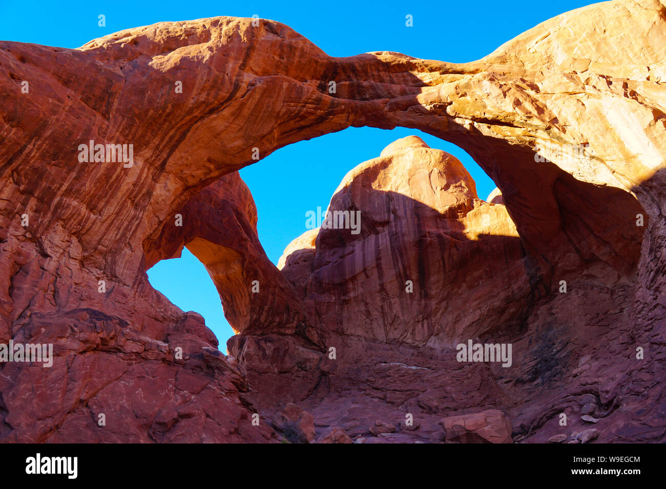 The amazing architecture of the double arch in Arches National Park on a bright autumn afternoon. Stock Photo