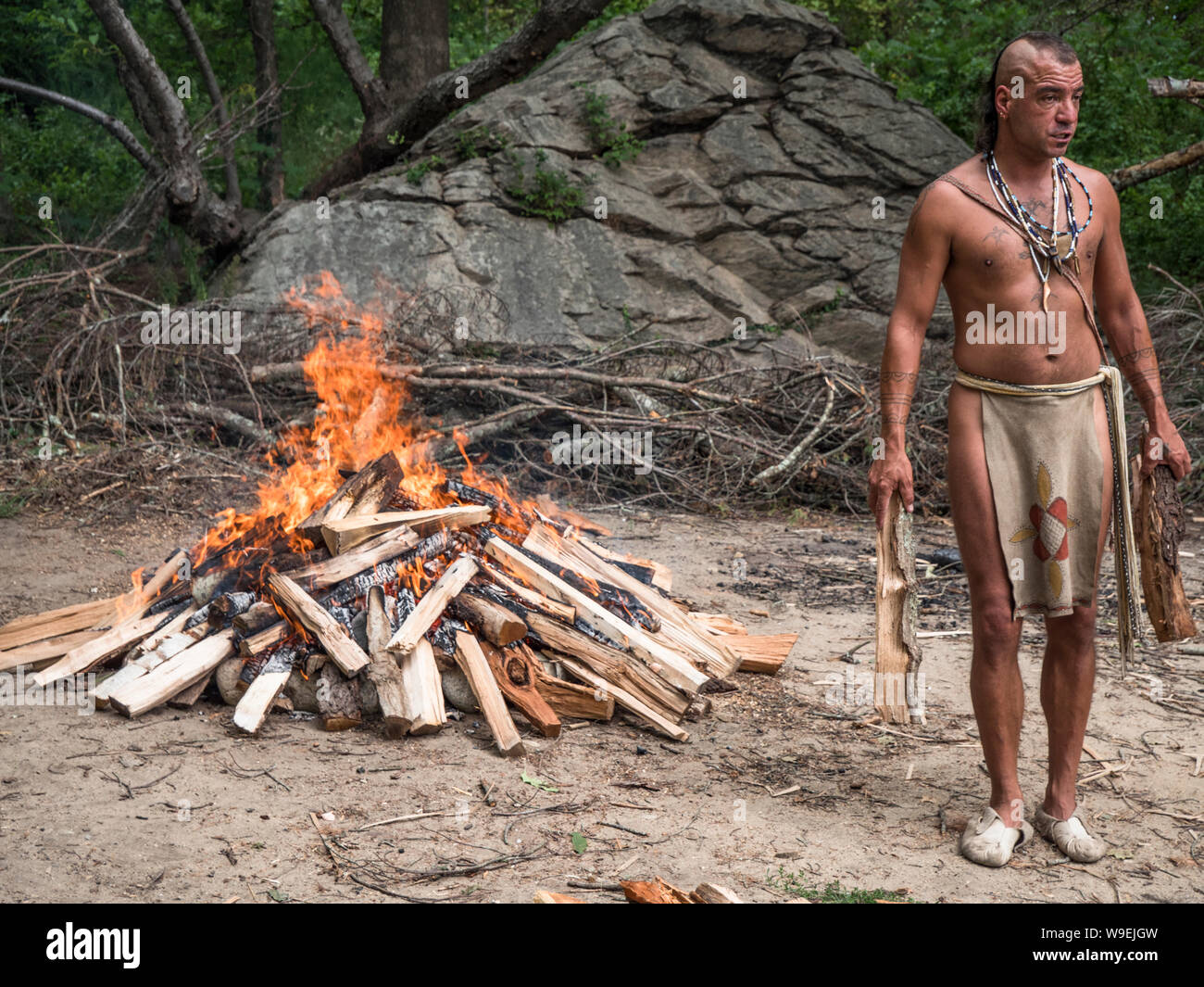Wampanoag man by a large open fire Stock Photo