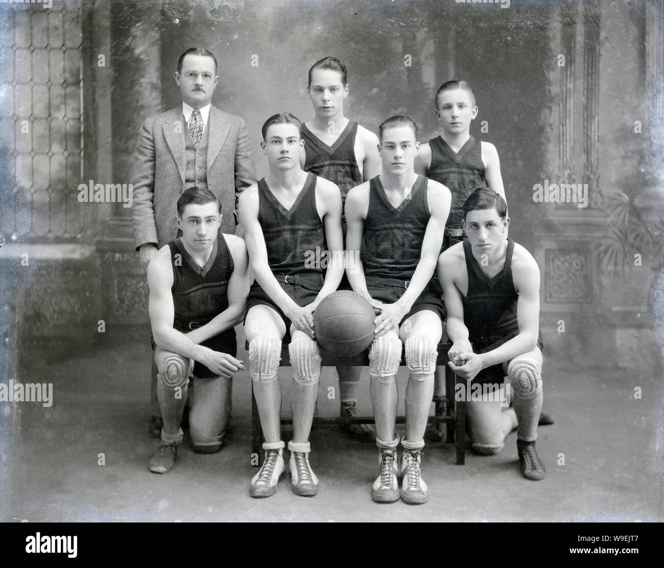 Antique c1915 LHS basketball team with coach photograph. Location unknown, USA. SOURCE: ORIGINAL ACETATE NEGATIVE. Stock Photo
