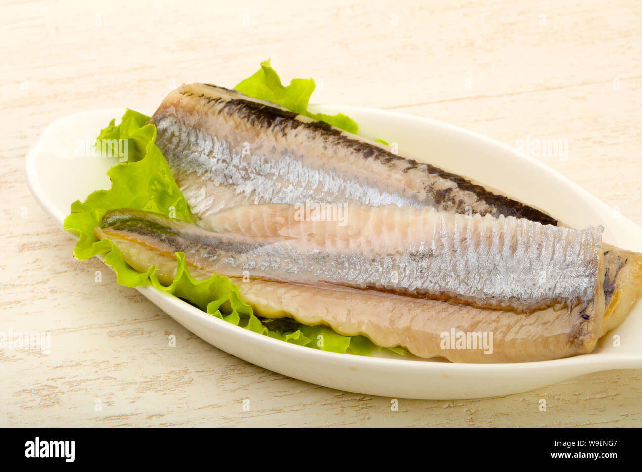 Herring fillet over salad leaves ready for eat Stock Photo Alamy