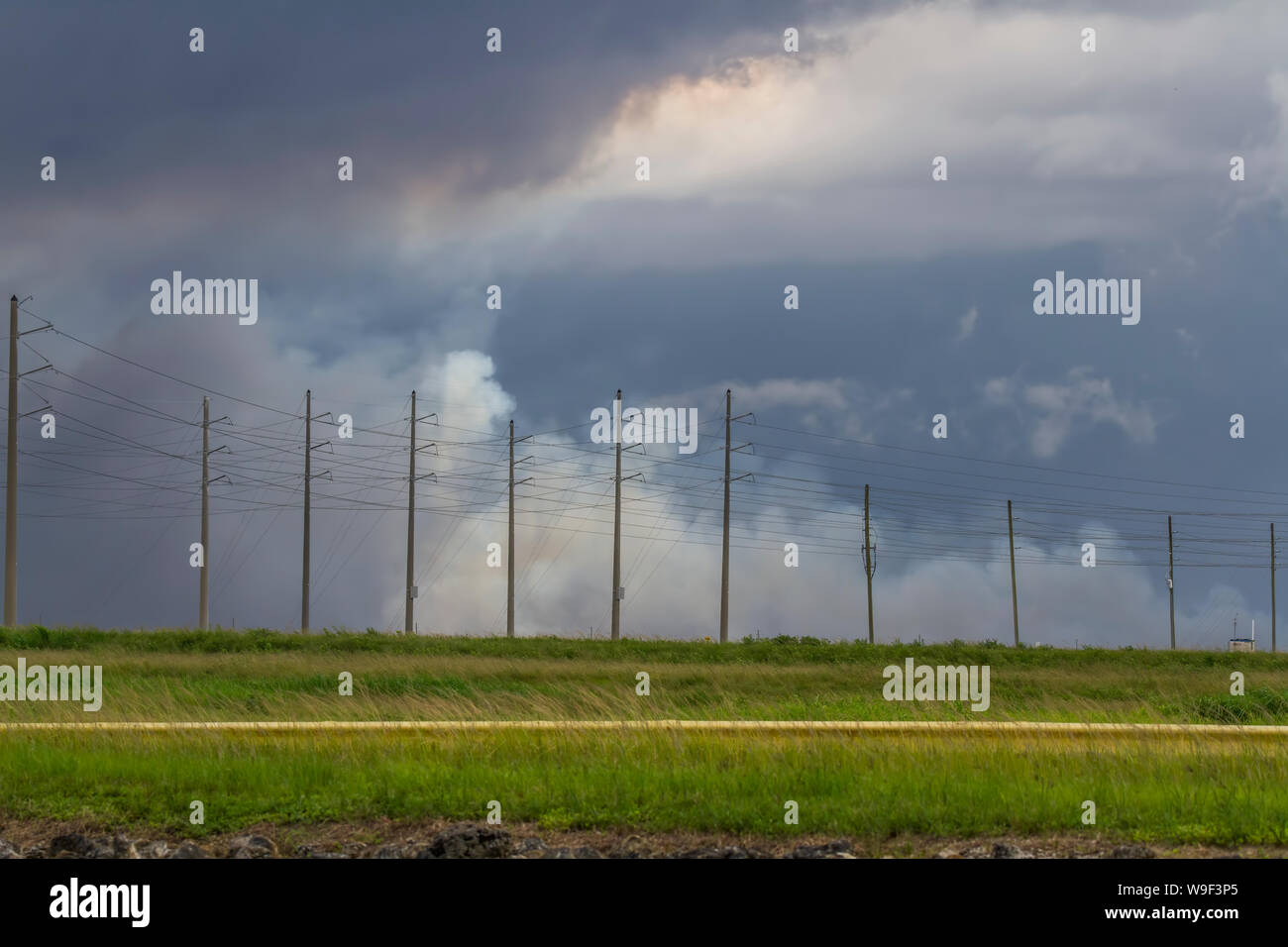 Approaching storms and a brush fire in the Northern Everglades. Stock Photo