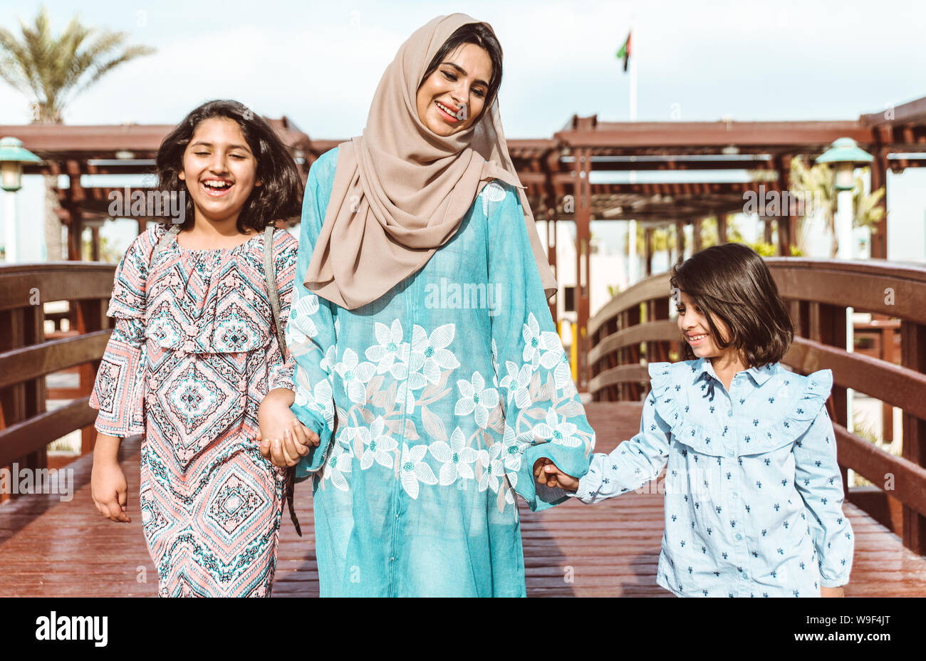 Mom and daughters spending time together at the park, in Dubai Stock