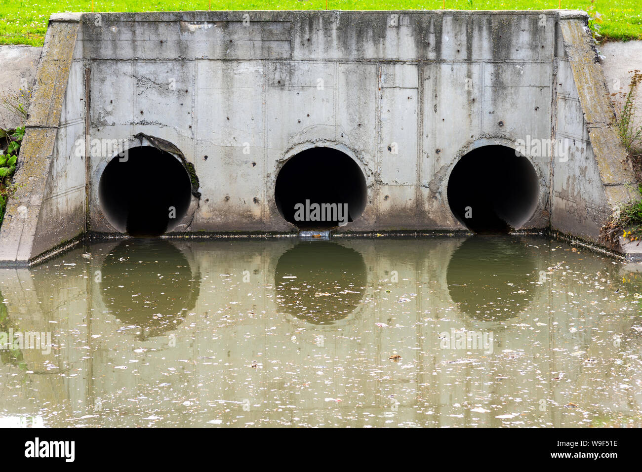 A drain pipe or sewage or sewage discharges waste water into a river. Wastewater or domestic wastewater or municipal wastewater that is a product of a Stock Photo