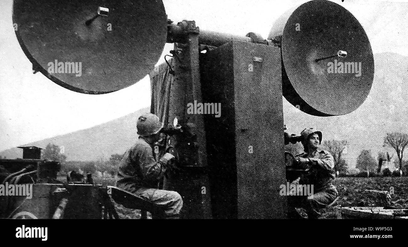 WWII - American soldiers operating the aircraft radar equipment  known as SCR-547 Mobile Microwave Radar-Optical Height Finder  which they nicknamed 'Mickey Mouse' Stock Photo