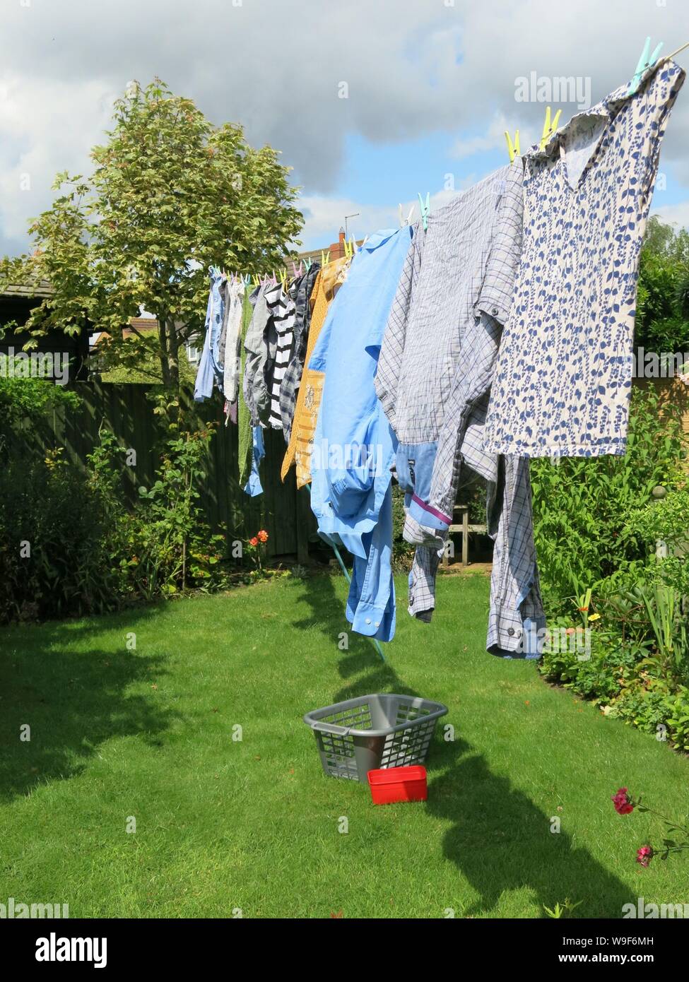 A washingline of clothes hung out with pegs on a clothesline to dry in
