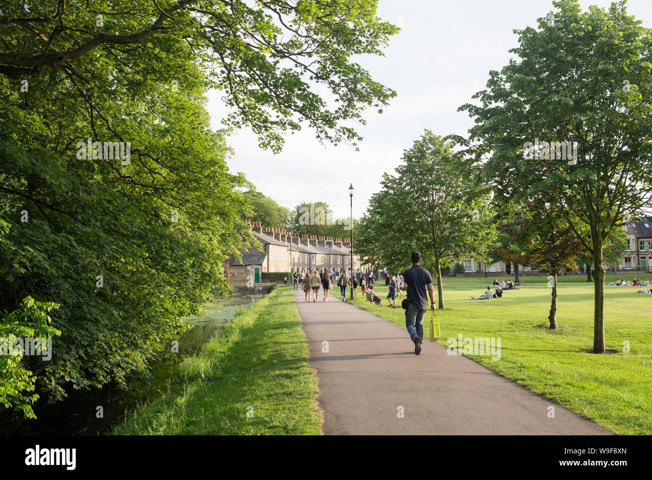 Cambridge, UK - June 2019: People enjoying the warm summer weather in Jesus Green public park, Cambridge, UK. Stock Photo