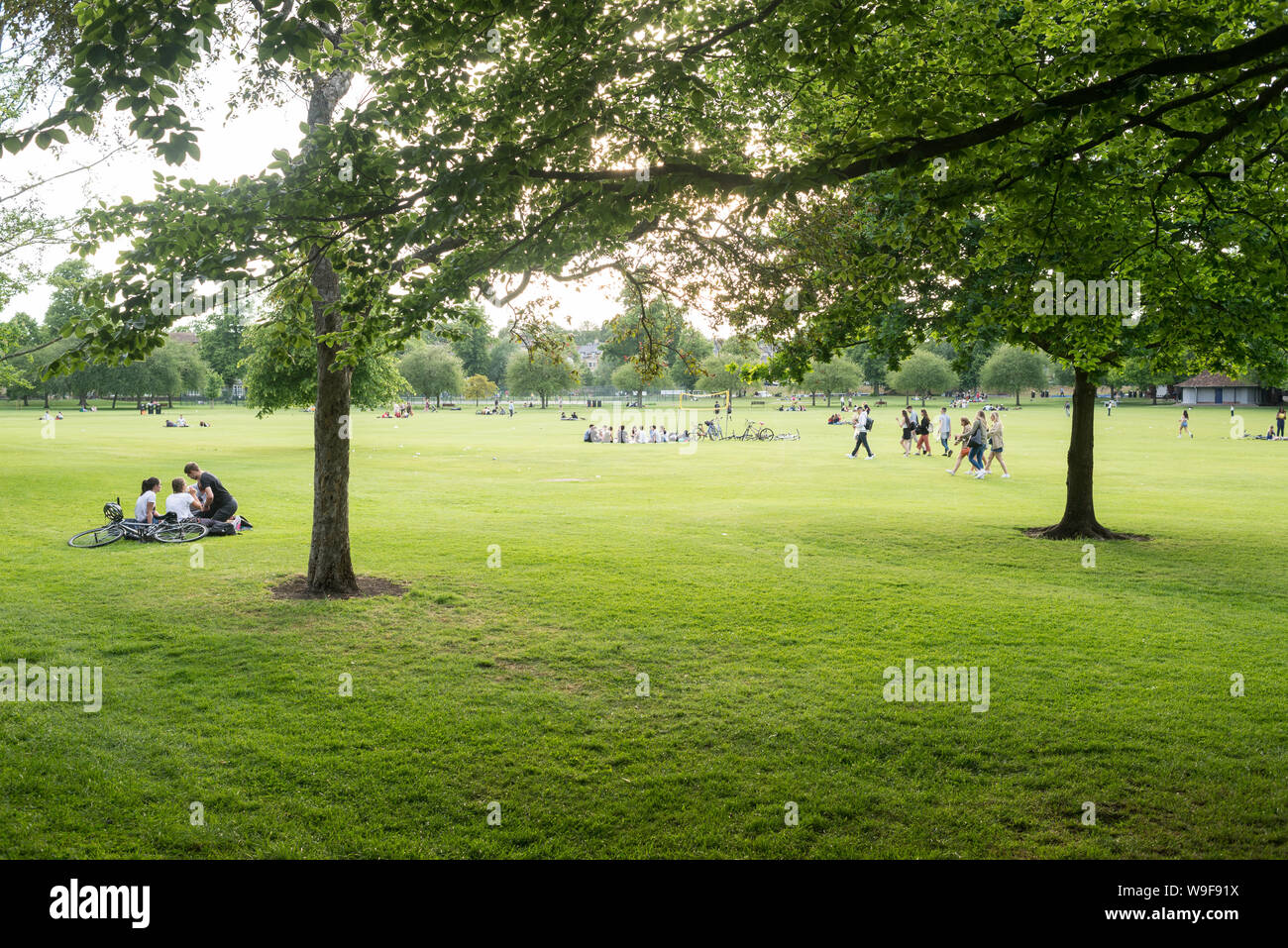 Cambridge, UK - June 2019: People enjoying the warm summer weather in Jesus Green public park, Cambridge, UK. Stock Photo