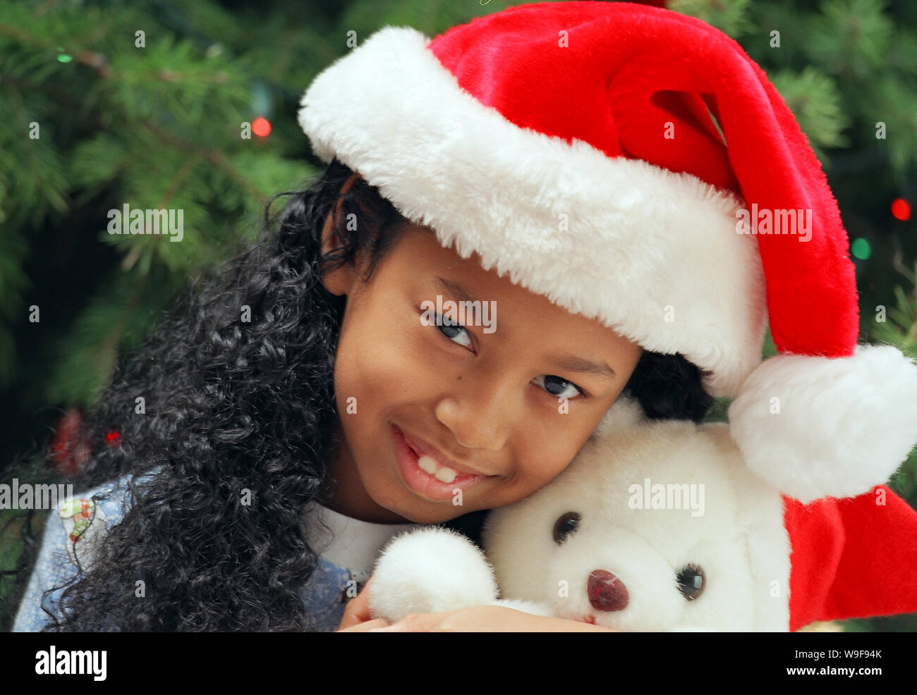 Girl holding a Christmas teddy bear Stock Photo