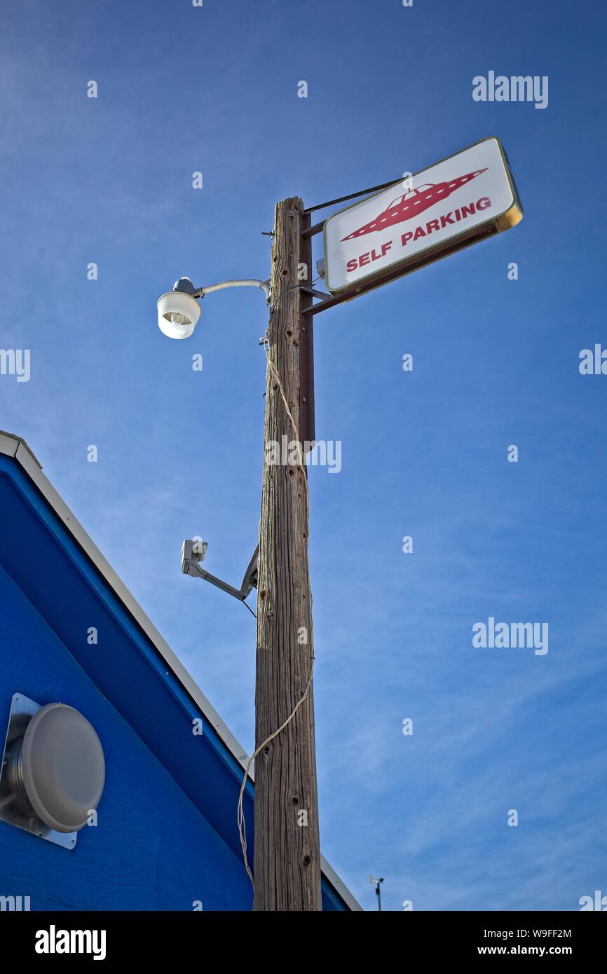 A telephone pole holding a sign showing parking place for extraterrestrial vehicles and Rachel Nevada at the Little A'Le'Inn, I'm gathering spot for U Stock Photo