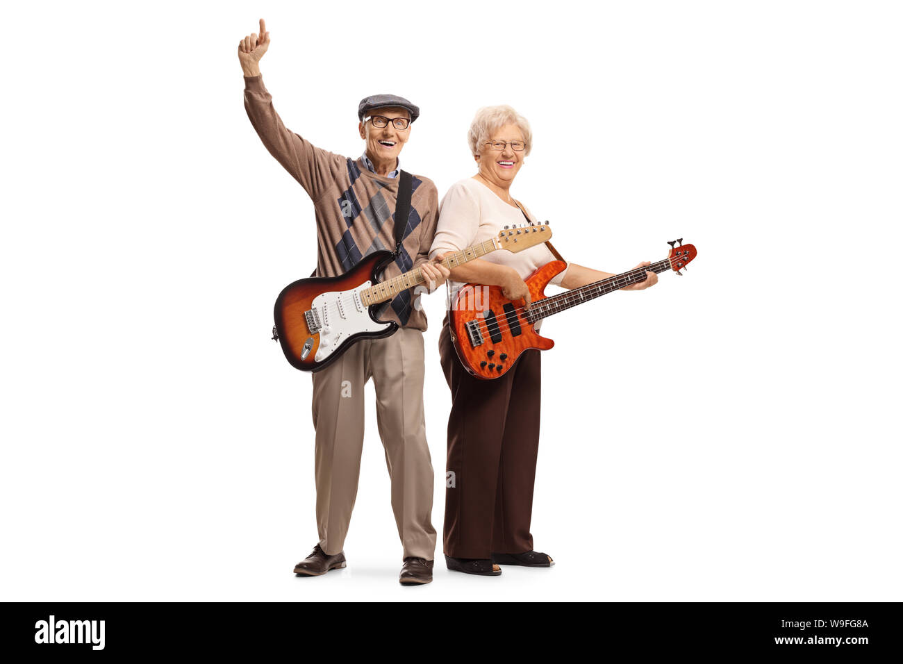 Full length portrait of cool elderly man and woman with electric guitars isolated on white background Stock Photo