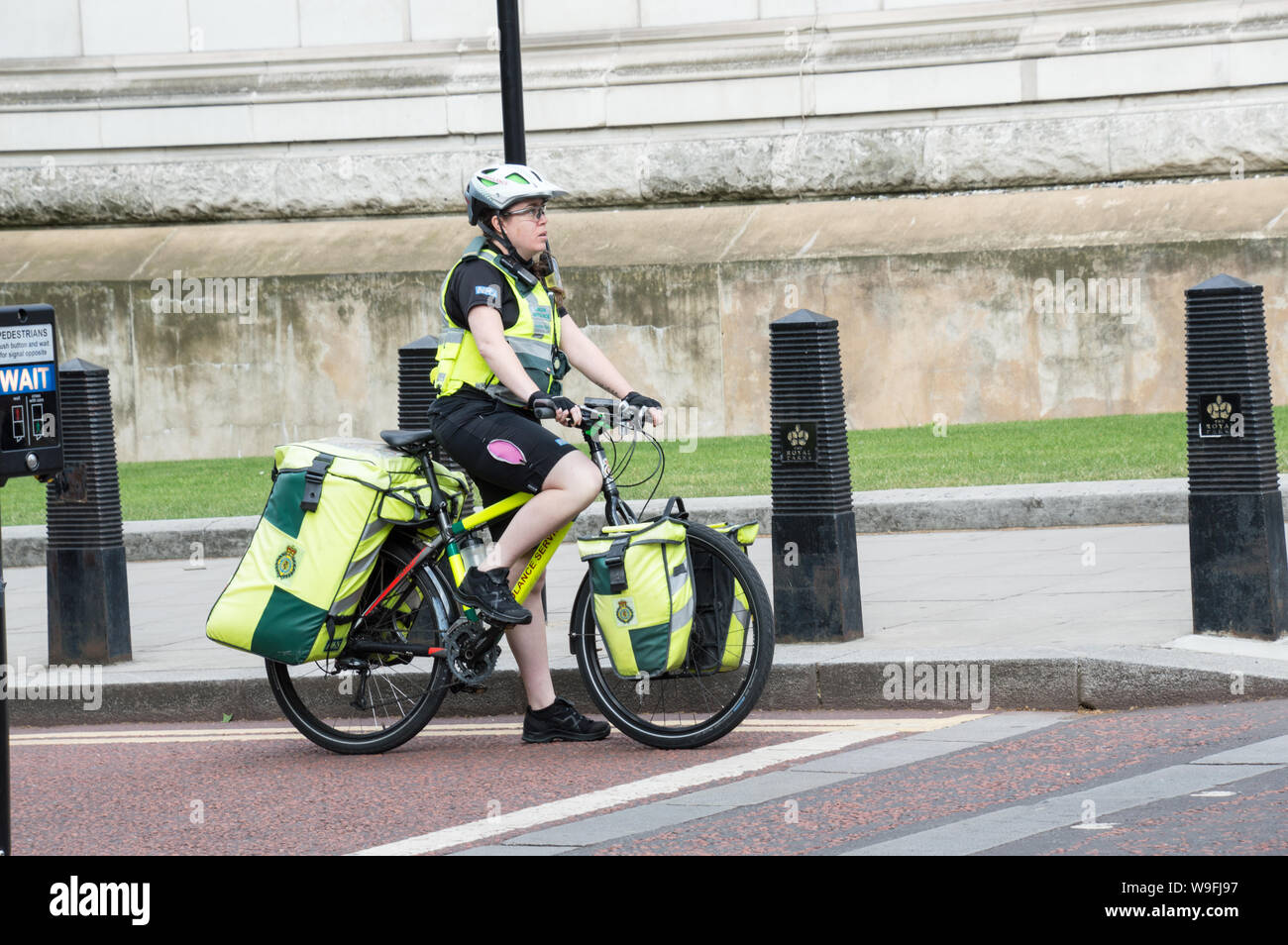 Paramedic in bicycle / bike at London signal waiting for signal to turn green Stock Photo