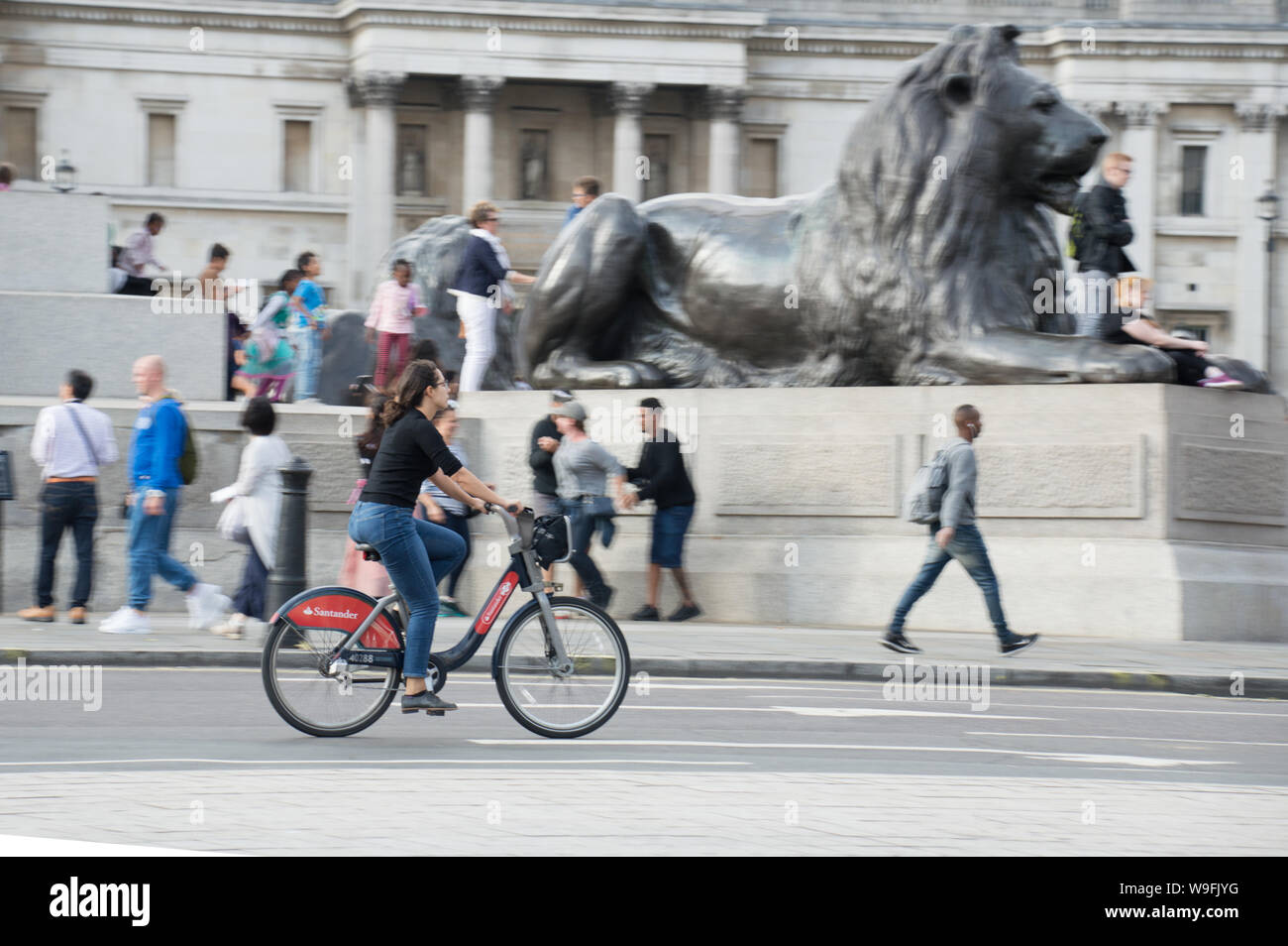 Woman riding bike in London trafalgar square using Santander bike sharing Stock Photo