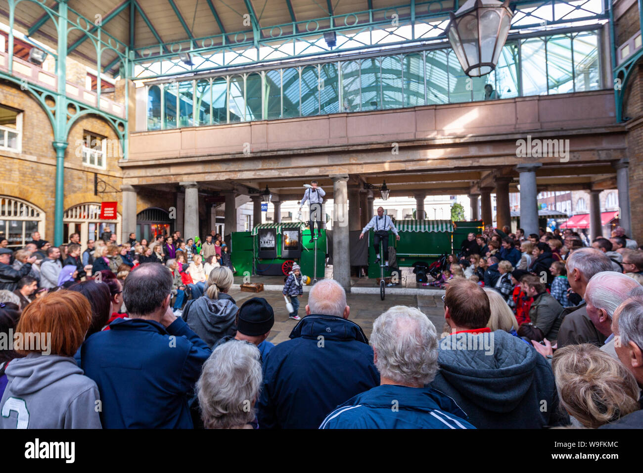 A street unicycles performer juggling in Covent Garden, London, England