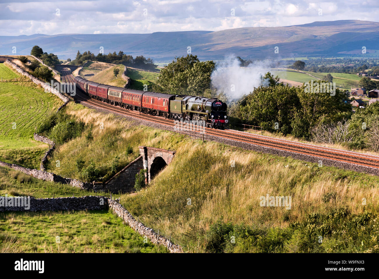Kirkby Stephen, Cumbria, UK. 13th Aug, 2019. 1940s steam locomotive 'British India Line' No. 35018 with 'The Dalesman' steam special at Birkett Common near Kirkby Stephen, Cumbria. Seen here on the return trip, the train ran from York to Carlisle and return, with steam haulage from Hellifield near Skipton to Carlisle and back. Credit: John Bentley/Alamy Live News Stock Photo