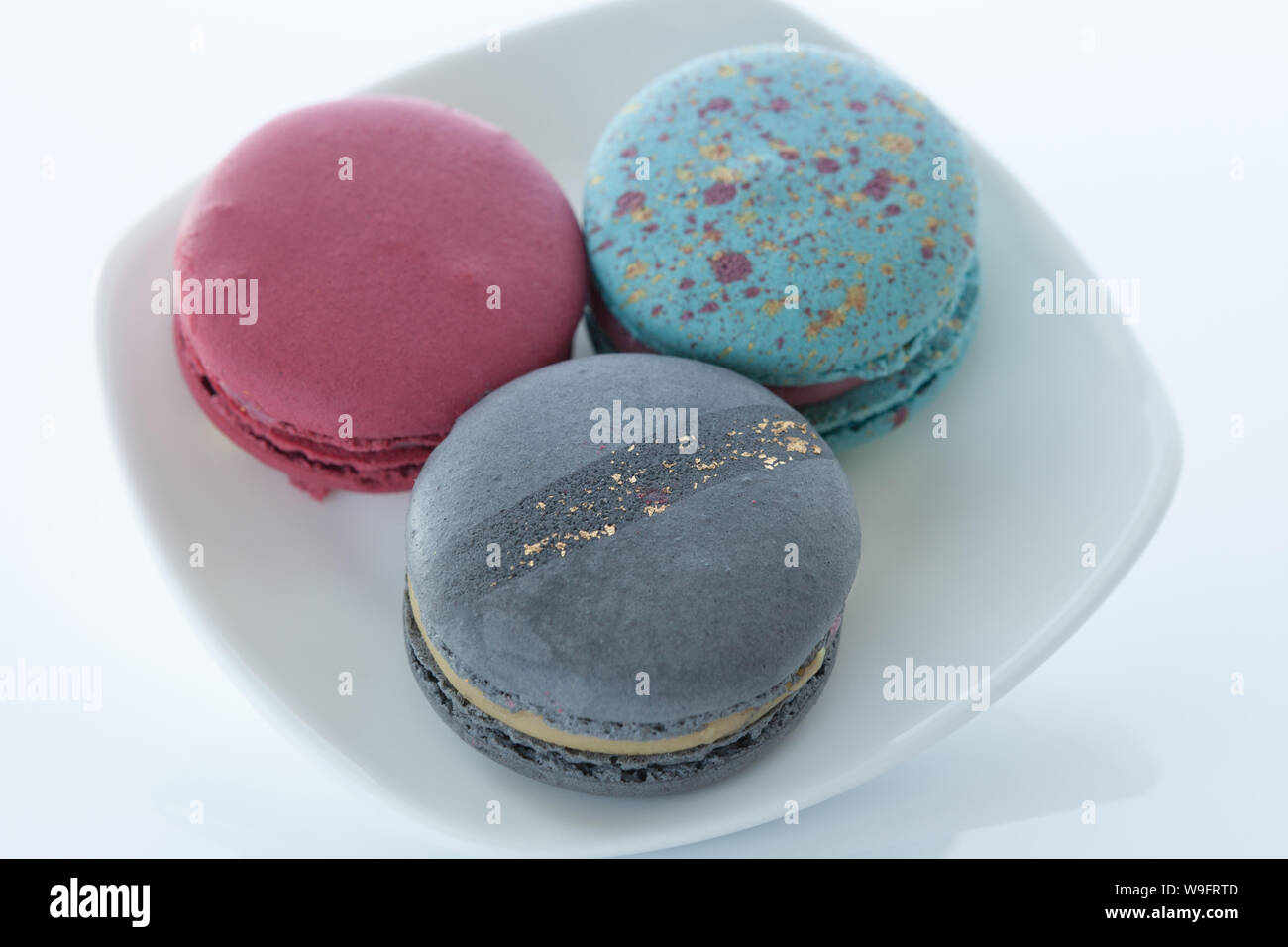 Macaroons on a white saucer and a light background Stock Photo