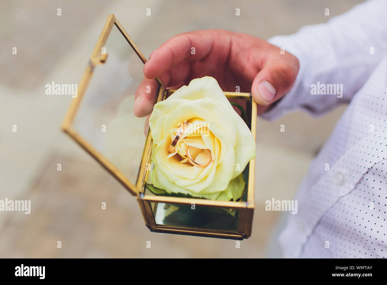 wedding rings in the box and a bouquet of the bride in hand. Stock Photo