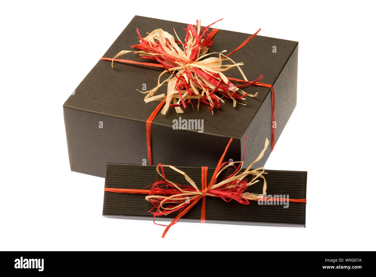 Black gift box wrapped with a red and tan natural raffia bow on a