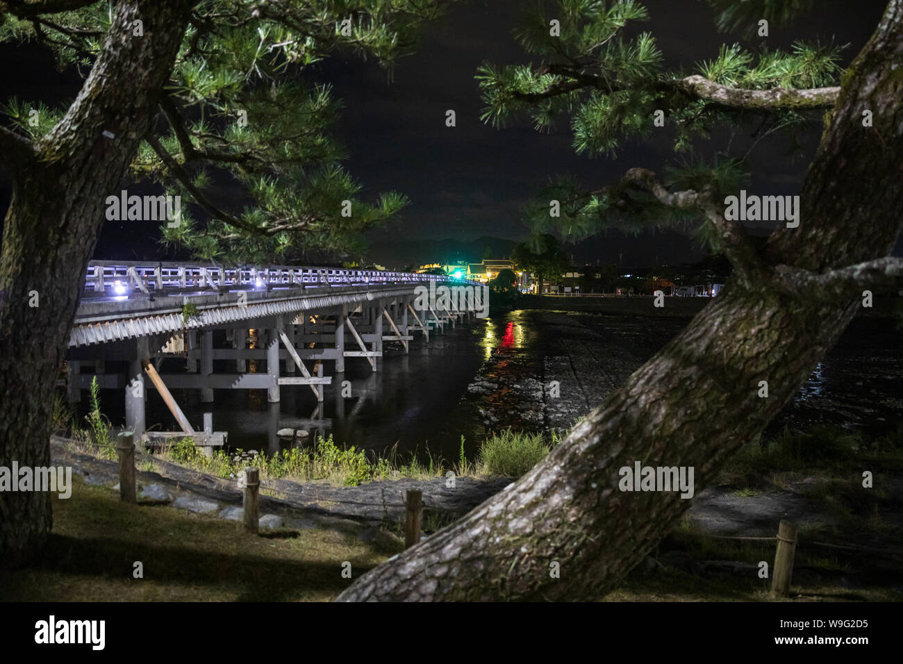 Night view of traditional wooden bridge leading to Arashiyama in Kyoto, Japan Stock Photo