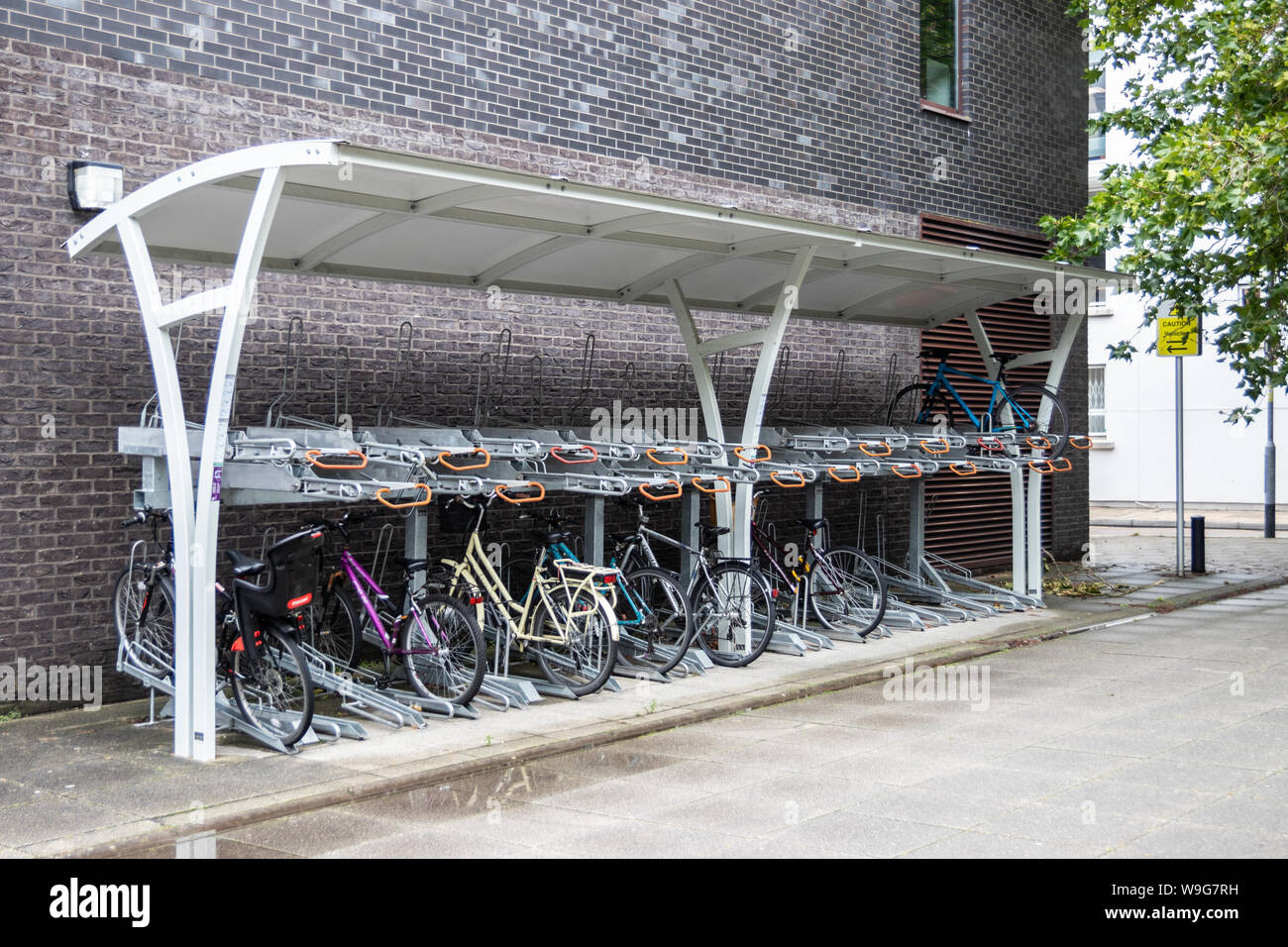 A two tier bike rack with bikes or cycles on both levels Stock Photo