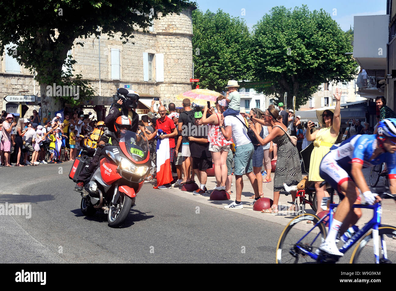 Passage Of An Advertising Motorbike Of France Tv Sport In The Caravan Of The Tour De France In Anduze Stock Photo Alamy