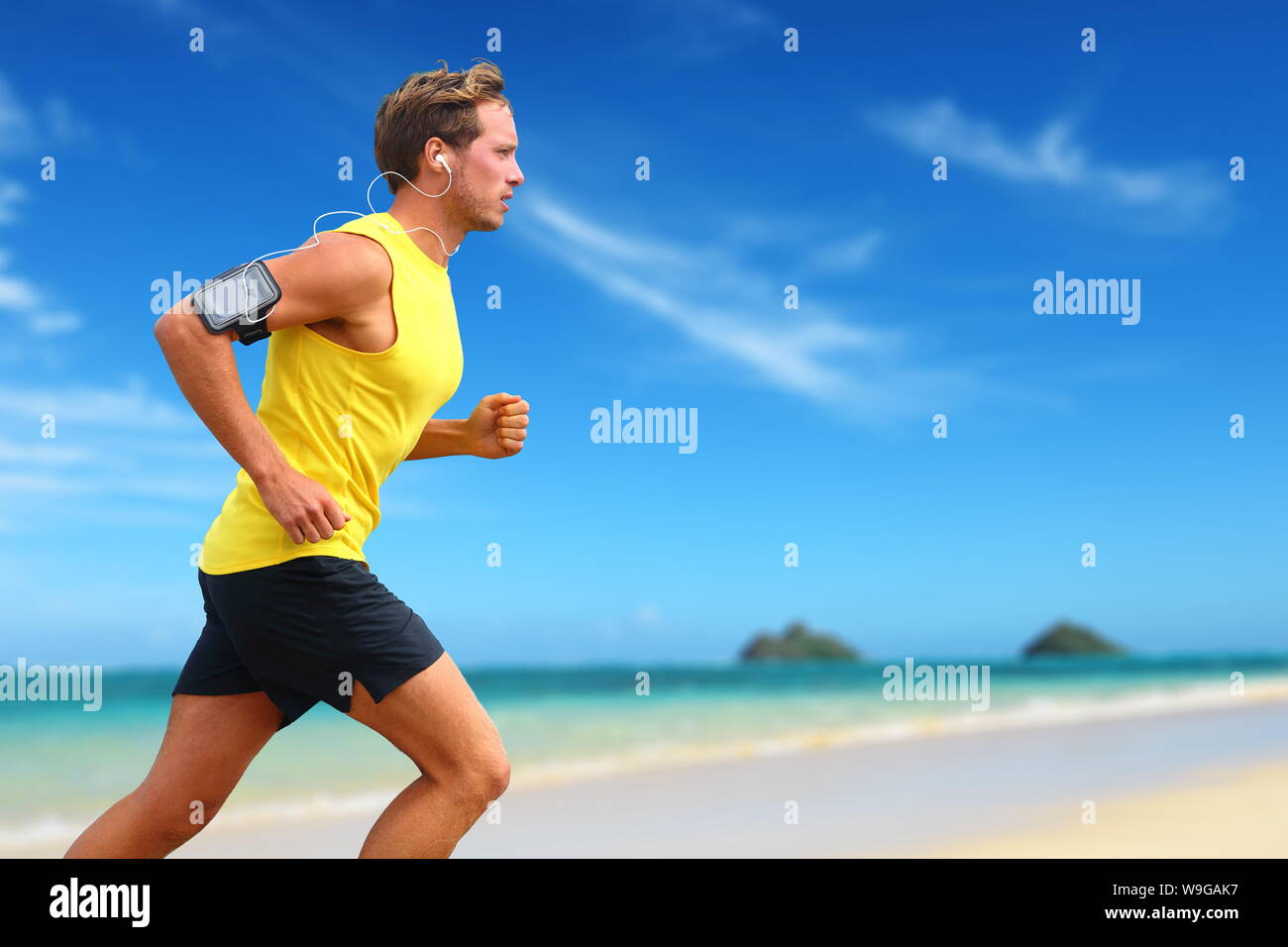 Oahu man running on beach hires stock photography and images Alamy