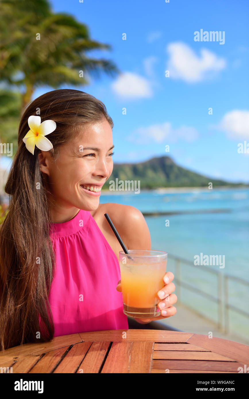 Cocktail woman drinking alcohol drinks at beach bar resort in Waikiki