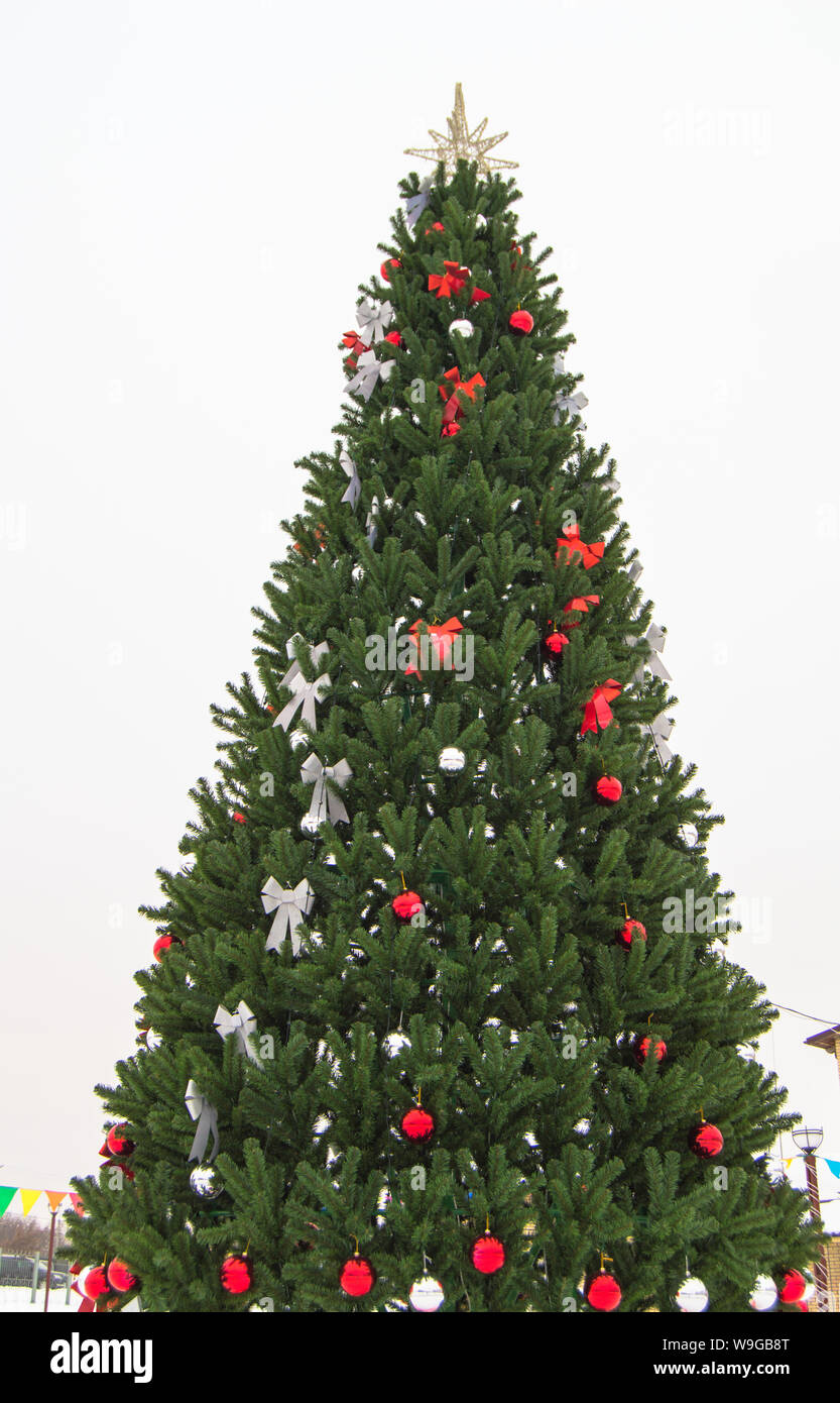 Decorated Christmas tree with red and white artificial stars bows balls ...