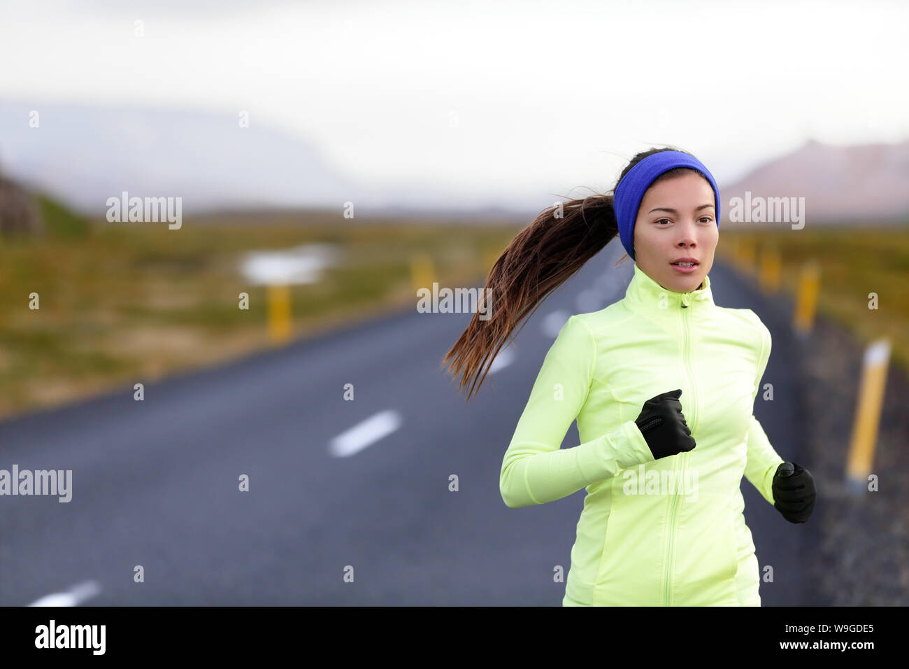 Female runner running in warm clothing for winter and autumn outside. Woman  runner training in cold weather living healthy active lifestyle Stock Photo  - Alamy
