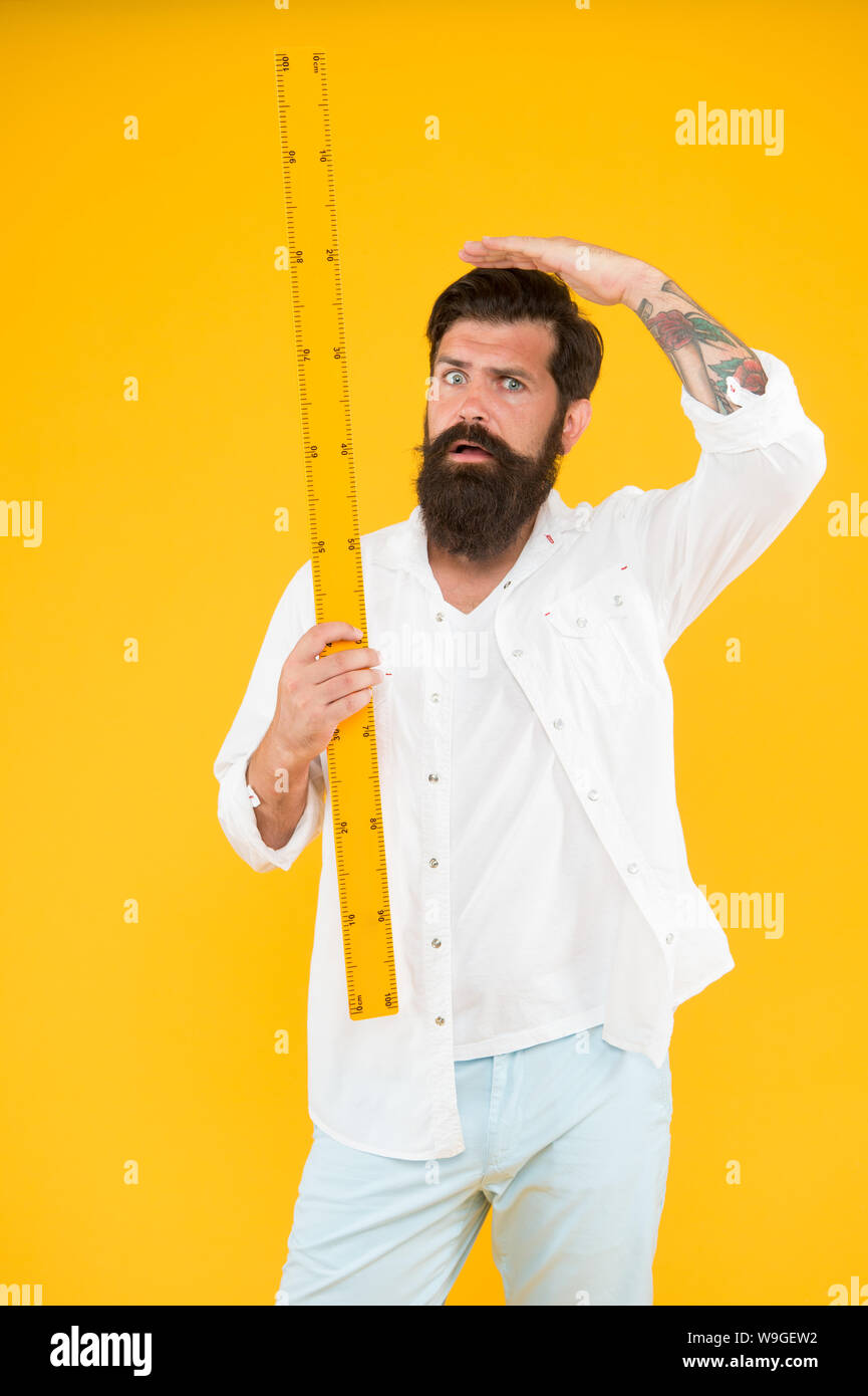 Small little big large. Does size really matter. One meter. Man bearded hipster holding ruler. Measure length. Size tall and length. Big size. Measure. Geometry theorem. Actual size. School teacher St...