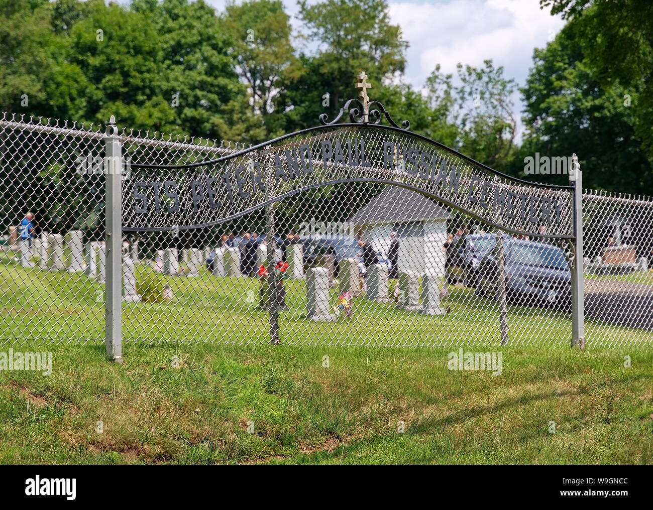 Meriden, CT USA. Aug 2019. The Saints Peter and Paul Russian Cemetery sign with funeral services in progess in the background. Stock Photo